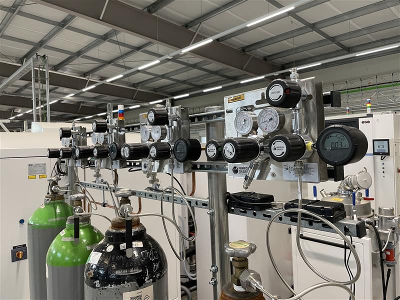 Industrial gas monitoring system with pressure regulators, flow measurement devices, and gas cylinders at the chesco ZWE research facility.